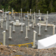 Several concrete and steel pillars staggered in a circular pattern