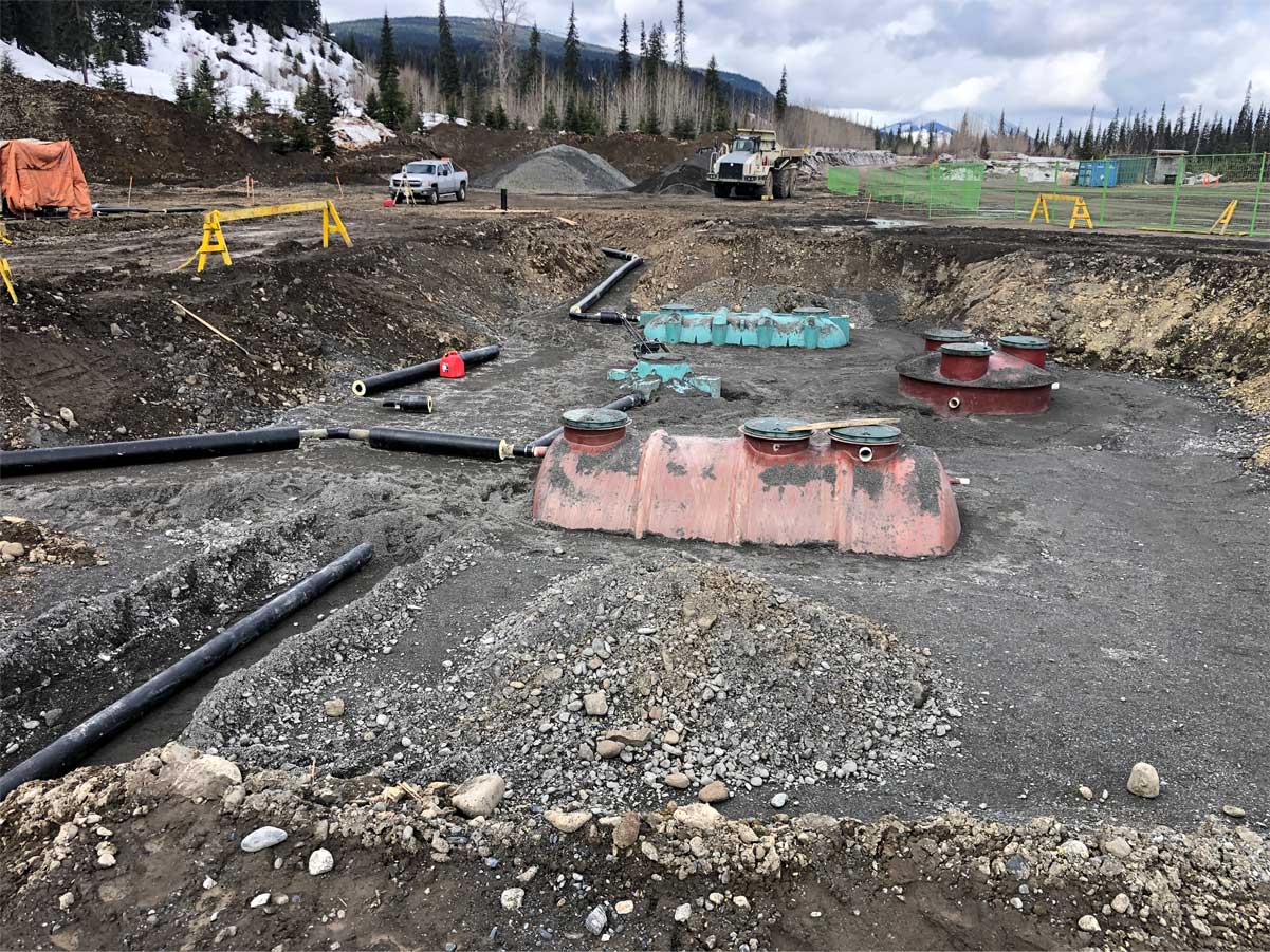 Piping and tanks being berried in foundation of upgraded camp