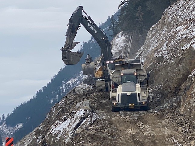 Heavy equipment working on cliffside