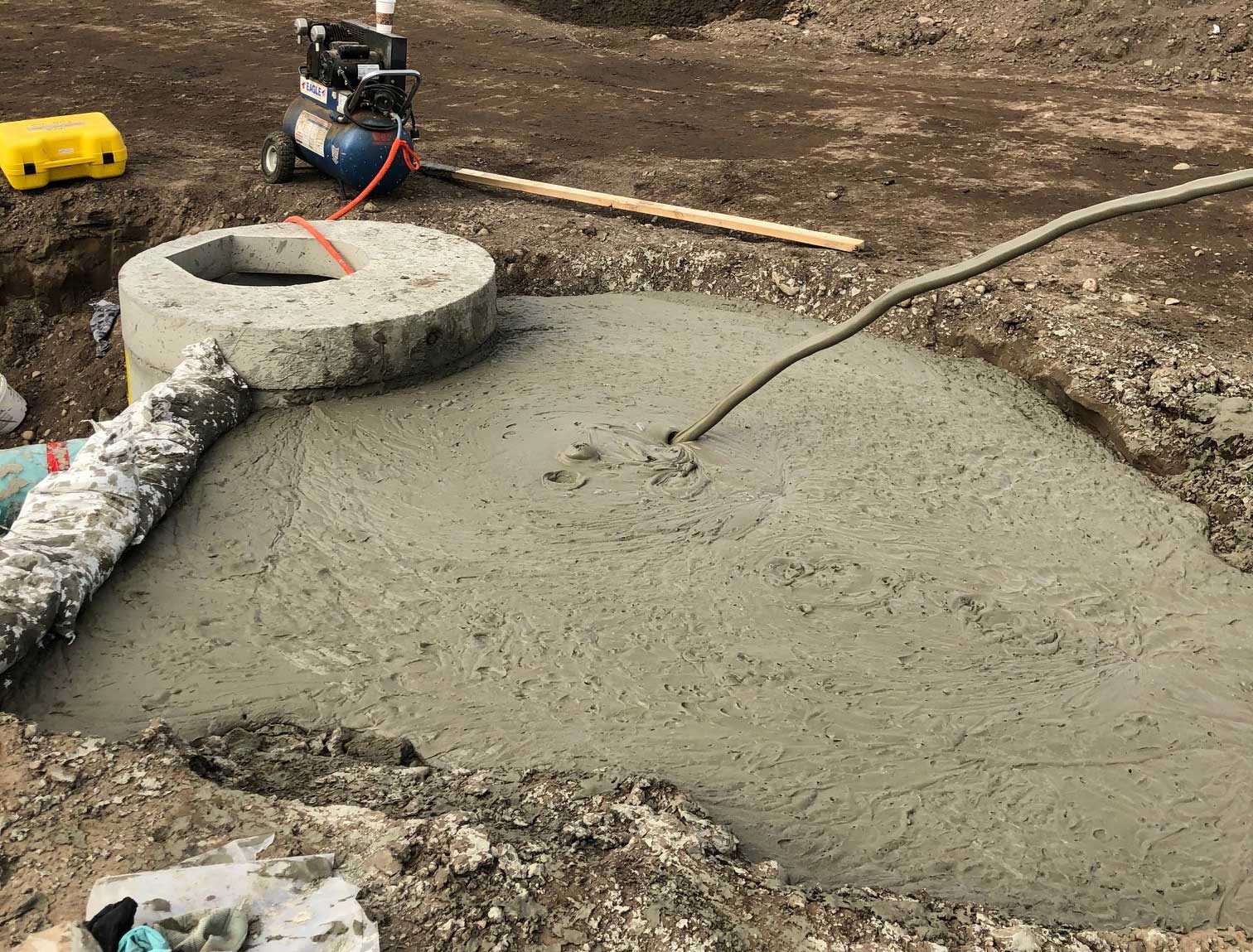 Concrete being poured at the Blue tubing at the Komatsu Manufacturing Plant