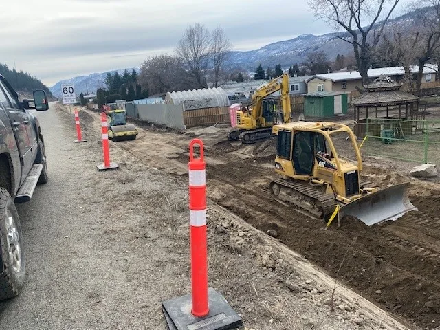 Heavy equipment and pilons organized near residential area